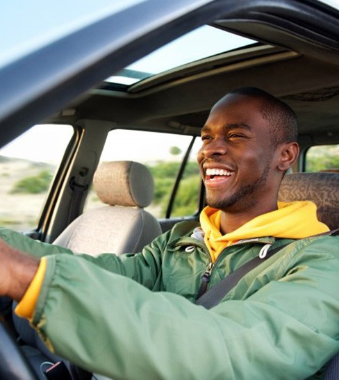 Man smiles while driving
