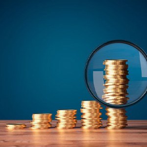 Coins examined with magnifying glass