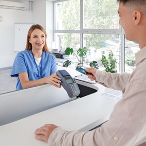 Dental team member accepting payment from patient