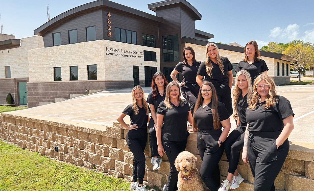 Dental team of Justyna Laska DDS smiling outside of dental office