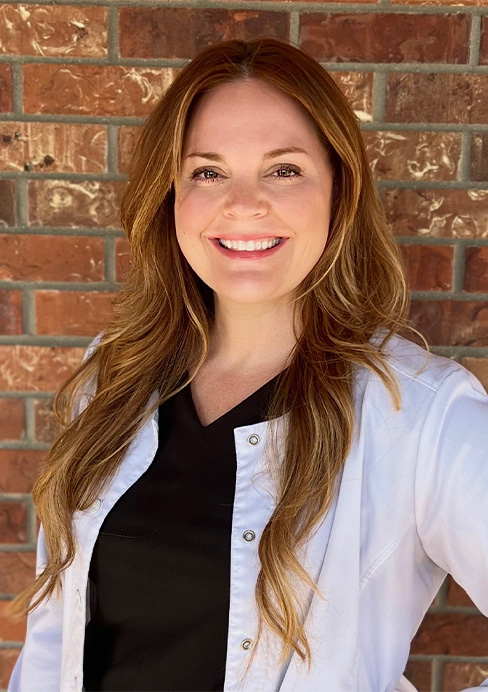 Doctor Justyna Laska next to a tree