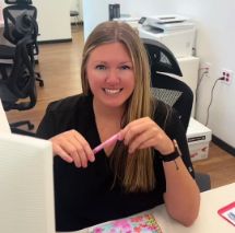 Woman sitting at front desk and smiling