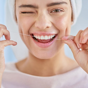 Woman flossing her teeth