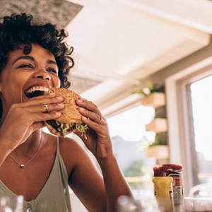 Woman enjoying a sandwich at a restaurant