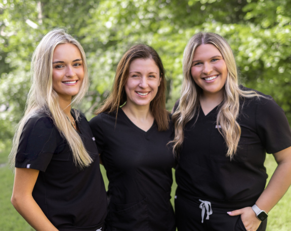Dental team group smiling at Justyna Laska, DDS.